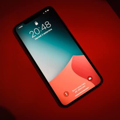 a close up of a cell phone on a red surface
