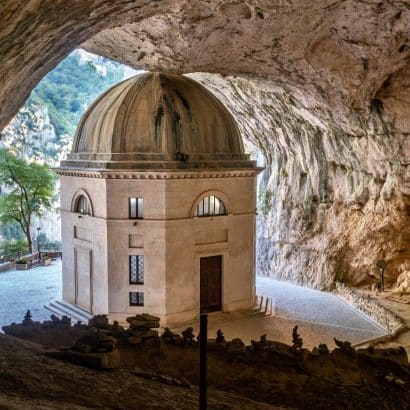 brown concrete dome building near body of water during daytime