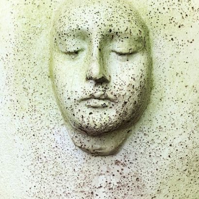 white human face carved on white wall